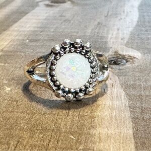 Silver ring with round opalescent center stone